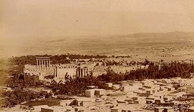 A panorama of ancient Baalbek, seen from a nearby hill. The ruins are the Roman temples of Bacchus (foreground) and Baal-Jupiter.